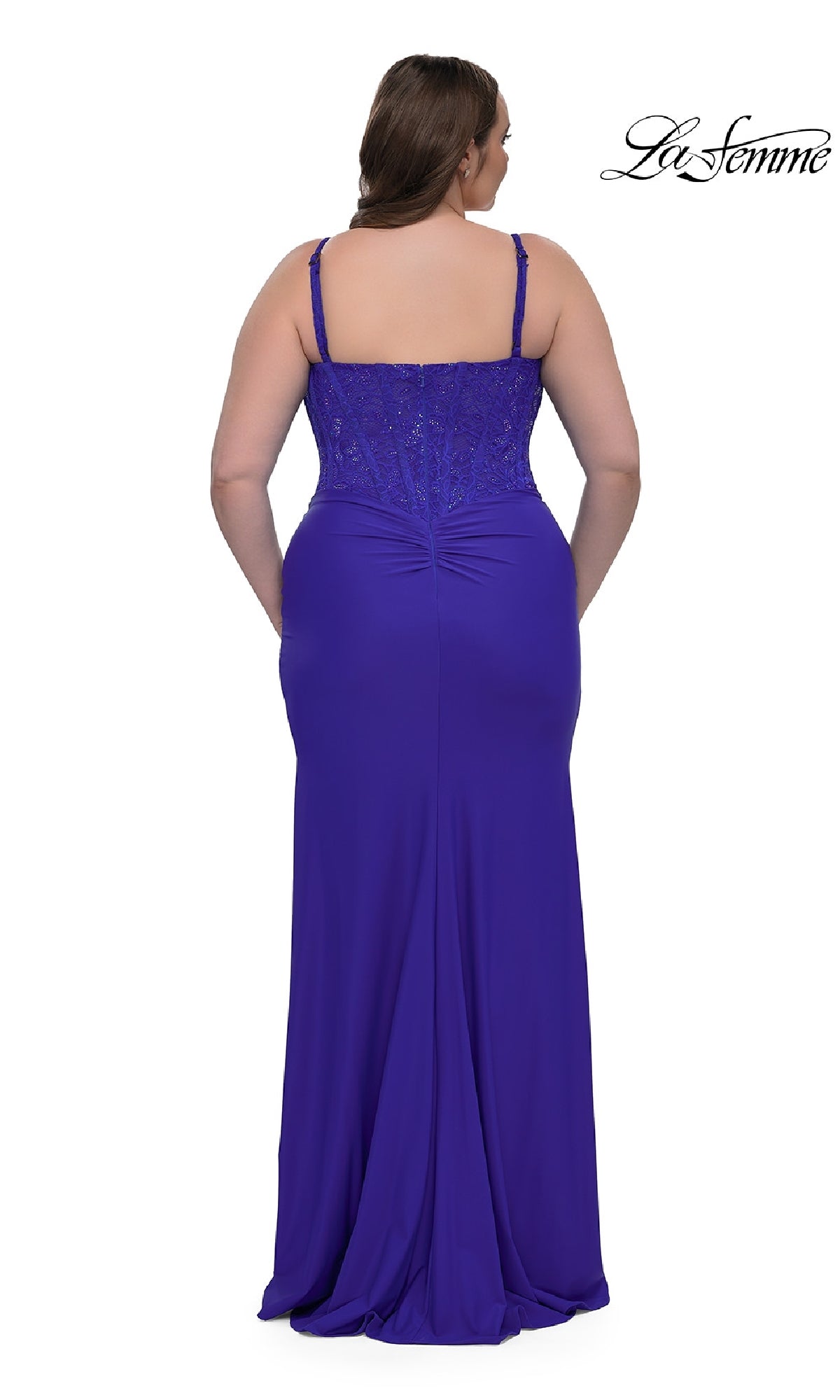Woman wearing the La Femme 32449 plus-size long corset prom dress, featuring a floor-length royal blue design with thin straps, a fitted beaded bodice, and an elegant gathered seam at the lower back.